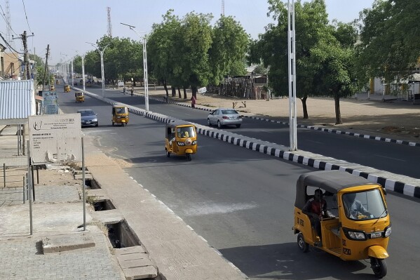 Taxis drive on a street in Maiduguri, Nigeria, Friday, March 14, 2025. (AP Photo/Joshua Olatunji)